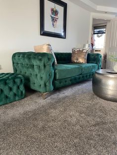 a living room filled with green couches and pillows