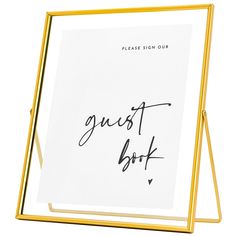 a sign that says guest book in black ink on a white paper with gold frame