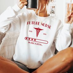 Nursing Student Sweatshirt "Future Nurse in Progress" Looking for the perfect addition to your wardrobe?  🎁 **Our Cozy Crewneck Sweatshirt** is the ideal choice for anyone seeking comfort and style in one package. Whether it's for a birthday, holiday, or just because, this sweatshirt is sure to become a favorite go-to piece, with our exclusive design adding a touch of flair. ️ Cozy Comfort** Crafted from a medium-heavy fabric blend of **50% cotton and 50% polyester** (8.0 oz/yd this sweatshirt Nursing White Coat Ceremony Outfit, White Coat Ceremony Outfit, Nurse In Progress, White Coat Ceremony, In Progress, Nursing Student Gifts, School Nurse, Future Nurse, Nurse Sweatshirt