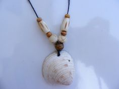 a necklace with shells and beads hanging from it