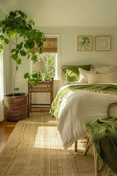 a bedroom with a bed, chair and potted plant on the side of the bed