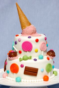 a cake decorated with candy and an ice cream cone