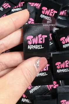 someone is holding onto some black and pink stickers with the words sweet apparel on them