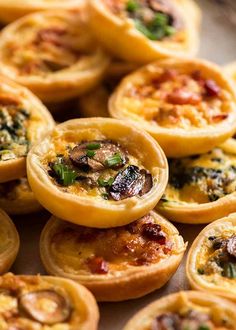 mini quiches filled with different types of toppings on top of each other,