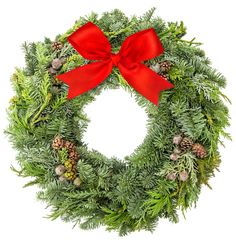 a christmas wreath with red bow and pine cones