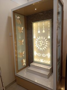 a display case in the shape of a sun with bells on it and lights inside