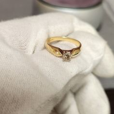 a gold ring sitting on top of a white towel