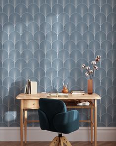 a desk with a blue chair in front of it and a wall paper behind it