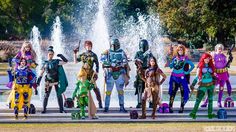 a group of cosplays standing in front of a fountain