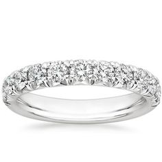 a white gold wedding ring with five stones on the side and two rows of diamonds in the middle