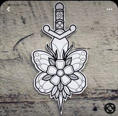 a sticker that is on the side of a stone wall with a flower and dagger