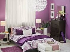 a bedroom with purple and white decor in shades of pink, lavender and lilac