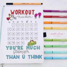 a notebook with the words workout tracker written on it next to markers and crayons