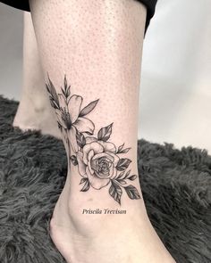 a woman's foot with a rose tattoo on the side of her leg and words written in black ink