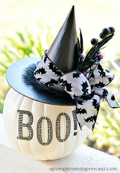 a black and white pumpkin with a witch hat on it's head that says boo