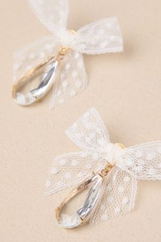 You'll take any chance you get to wear spectacular accessories like the Petit Moments Successful Elegance White Tulle Bow Rhinestone Earrings! These too-cute earrings offer a darling aesthetic thanks to chic bows of white lace ribbon (with a dainty polka dot design throughout), that sit above dangling, clear teardrop-shaped rhinestones that shimmer and shine within gold-toned settings. Post backs. 1. 25'' Long And 2'' Wide. 45% Lace, 35% Glass, 10% Brass, 10% Stainless Steel. Imported. Lulus | S White Lace Ribbon, Tulle Bow, Tulle Bows, Shimmer And Shine, Shimmer N Shine, White Tulle, Lace Bows, Polka Dot Design, Lace Ribbon