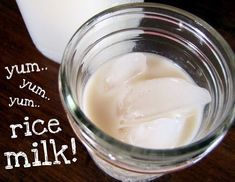 a glass jar filled with milk sitting on top of a wooden table