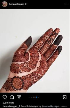 a hand with henna tattoos on it