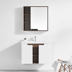 a white sink sitting under a mirror next to a wooden cabinet and chair in a room