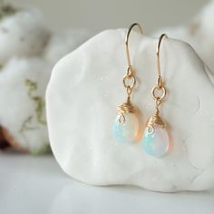 Connect to your inner self and to your emotions when you wear these fire opal drop earrings. Each dangling 14k gold filled earring frames your face while also catching the eye of your friends and family. High quality, hypoallergenic 14k gold filled setting ensures a long-lasting pair of earrings that you can wear over the years. Opal's energy provides the inner love we all need, to help positively live our days. Material Details The stones are genuine, Ethiopian fire opals Hypoallergenic 14k gol Opal Teardrop Earrings As Gift, Teardrop Opal Earrings As A Gift, Teardrop Opal Earrings For Gift, Teardrop Opal Earrings In Gold, Elegant Ethiopian Opal Earrings As Gift, Gold Ethiopian Opal Earrings For Gift, Earring Frame, Fire Opal Earrings, Opal Drop Earrings