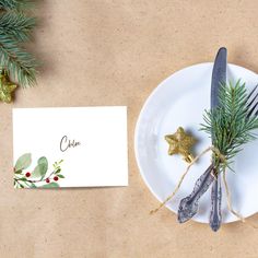 a white plate topped with a fork and knife next to a place card on top of a table