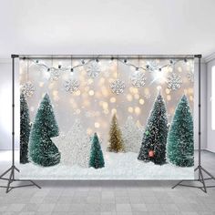 a christmas scene with trees and lights in the snow, on a wallpapered background