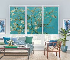 the living room is decorated in blue and green tones with white flowers on the branches