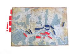 an old map with red pins on it