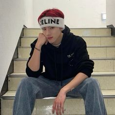 a young man sitting on the steps wearing a hat that reads'eline '