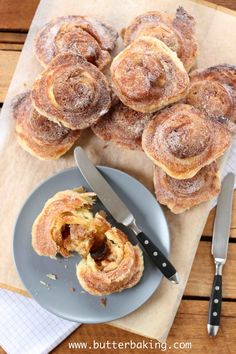 some cinnamon rolls are on a plate with a knife