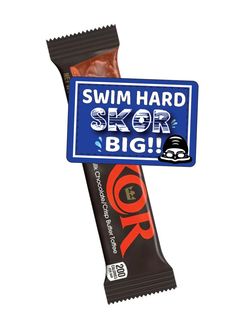 a blue sign that says swim hard, skor bigr on it next to a bar of chocolate