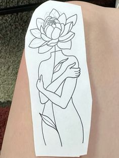 a person's arm with a drawing of a woman holding a flower on it