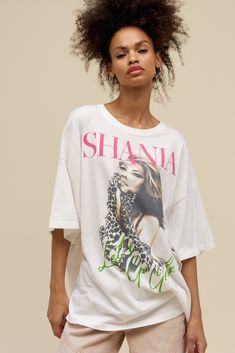 a woman wearing a white shirt with the words shani on it and leopard print