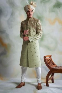 Mint green sherwani with floral embroidered thread work. Paired with cotton silk kurta, churidar pant.
Components:3
Pattern:Embroidered
Type of Work:Thread work
Neckline:Mandarin collar
Sleeve Length:Full sleeves
Fabric:Raw silk, Cotton silk
Color:Green
Other Details:
Concealed placket
Note: Safa worn by the model is not for sale
Occasion:Wedding,Groom  - Aza Fashions Cream Sherwani, Green Sherwani, Engagement Dress For Groom, Seema Gujral, Silk Pajama Pants, Sherwani For Men, Green Thread, Silk Kurta, Engagement Dresses