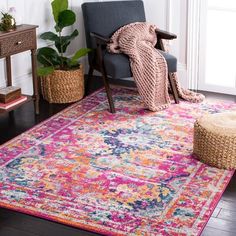 a living room area with a chair, rug and potted plant