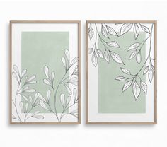 two framed art prints with leaves on them, one in green and the other in white