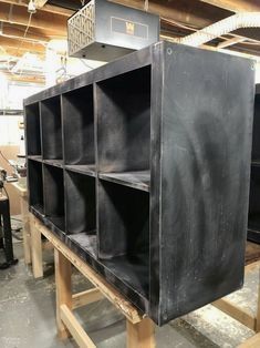 the shelves are made out of metal and have black plastic coverings on each shelf