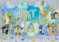 a birthday cake surrounded by stuffed animals and balloons