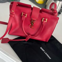 Gently Used Ysl Red Monogram Cabas Leather Tote. Some Wearing On The Inside And On The Bottom Corners As Shown In The Picture’s. Dust Bag Included. Measurements: Width: 10” Height: 7” Depth: 4” Saint Laurent Bags, Saint Laurent Bag, Womens Tote Bags, Leather Tote, Saint Laurent, Dust Bag, Monogram, Leather, Red