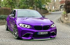 a purple car parked on the side of a road