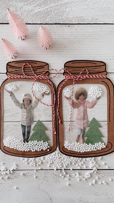 two mason jars are decorated with christmas decorations