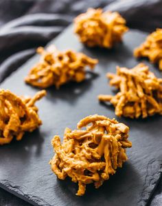 some cookies are sitting on a black plate and ready to be eaten by someone else