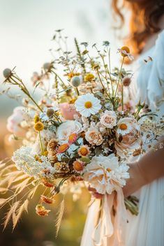 a woman holding a bouquet of flowers in her hands