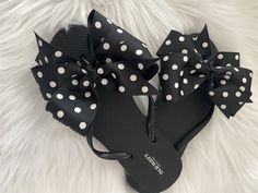 A pair of Old Navy flip flops decorated with a black grosgrain ribbon adorned with white polka dots. Ribbons are hand sewn to the shoe by me!! Super cute and fun!! Great for poolside or the beach, adorable for anywhere!! Three loops of one and a half inch ribbon made into a pinwheel bow that measures approximately 5 inches wide. Ends are heat sealed for no fraying. I'll be coming out with more colors soon so come back and visit!! Thank you for stopping by!! Custom requests are always welcome. Pl Black Bow Sandals For Summer, Summer Bow Flip Flops With Open Toe, Casual Summer Flip Flops With Bow, Summer Beach Flip Flops With Bow, Adjustable Bow Sandals For Beach, Adjustable Bow Sandals For Vacation, Cute Bow Sandals For The Beach, Adjustable Black Summer Flip Flops, Adjustable Cute Flip Flops For Summer