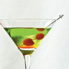 a martini glass filled with green and red liquid