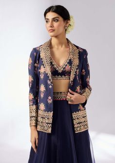 This elegant navy blue lehenga set showcases a floral embroidered jacket paired with a matching blouse and a flowing skirt. The intricate detailing and sophisticated design make it an ideal choice for festive occasions and weddings, offering a blend of timeless elegance and modern style. Festive Party Blazer With Resham Embroidery, Unstitched Elegant Choli With Floral Embroidery, Formal Sharara With Floral Embroidery, Formal Unstitched Sharara With Floral Embroidery, Elegant Unstitched Choli With Floral Embroidery, Unstitched Elegant Floral Embroidered Choli, Elegant Unstitched Floral Embroidered Choli, Blue Festive Suits With Dupatta, Blue Suits With Dupatta For Festive Occasions