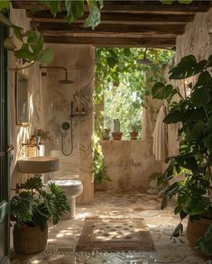 an open bathroom with plants in the corner