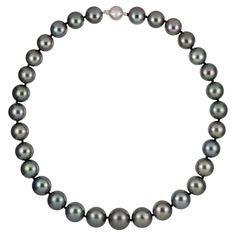 A graduated silver/grey Tahitian pearl necklace, the pearls graduating from 15.5mm to 12mm from the centre, double knotted and fitted with a matte white gold ball clasp set with eight round brilliant cut diamonds of 0.04 carats in total, bearing the convention marks of 18ct gold, London, measuring approximately 42.5cm in length and 31 pearls in total, gross weight 103.1 grams. A Tahitian pearl necklace in very good condition. This superb grey Tahitian pearl necklace comes from the collection of Grey Pearl Necklace, Tahitian Pearl Necklace, Vintage Jewelry Necklace, Jewel Necklace, Her Majesty The Queen, Cultured Pearl Necklace, Tahitian Pearls, Vintage Jewels, Pearl Grey