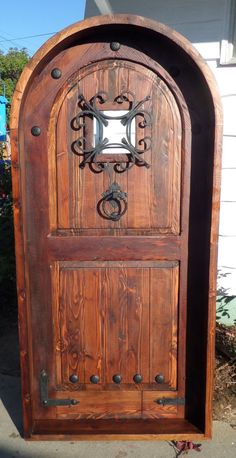 an old wooden door with iron work on it