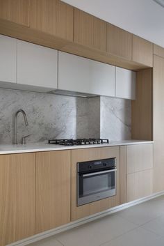 a kitchen with marble counter tops and wooden cabinets